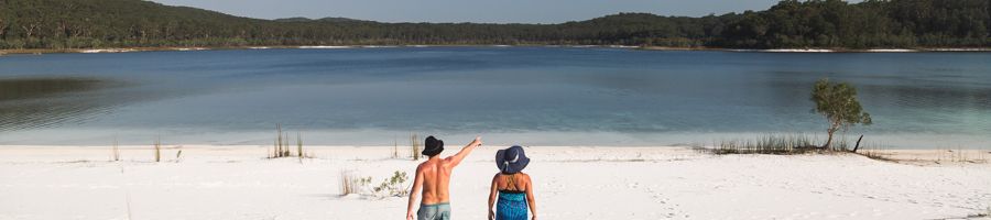 Couple walking on the sand towards Lake McKenzie