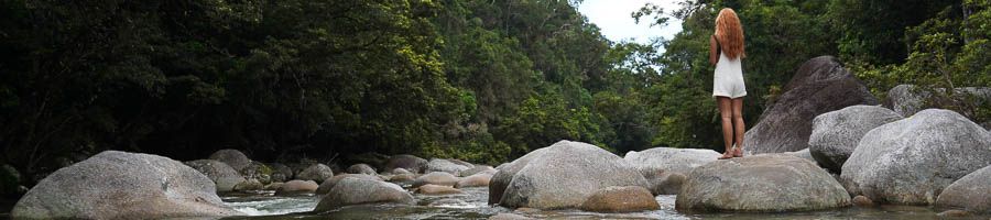 girl standing over rocks in Mossman Gorge