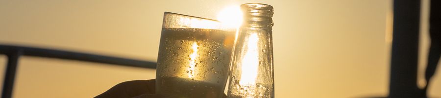 Sunset Drinks Drinks clinking on a boat at sunset