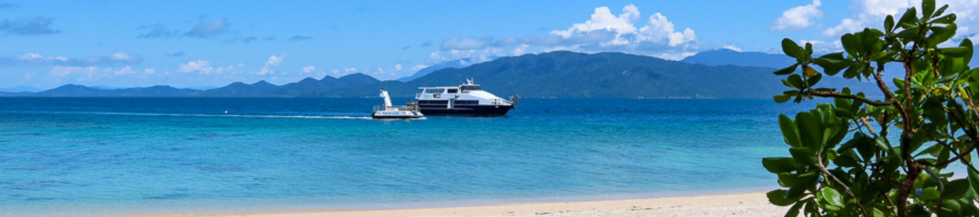 view of Frankland Islands boat and semi-submersible from the beach on Normanby Island