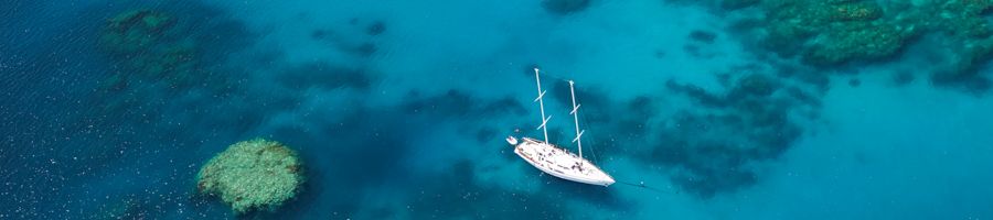 Summer Jo A sail boat in the ocean surrounded by blue water