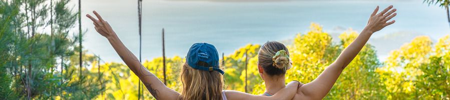 A bushwalk in the Whitsundays Two girls at the end of a bushwalk, looking out at an island in the Whitsundays