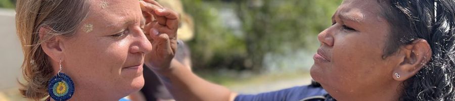 woman getting her face painted 