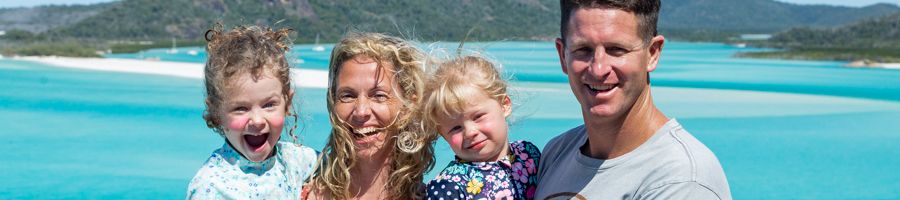 Family posing at Hill Inlet Lookout