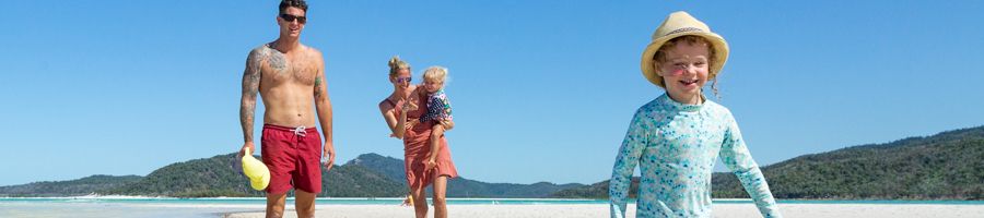 Family playing in the sand on Whitehaven Beach