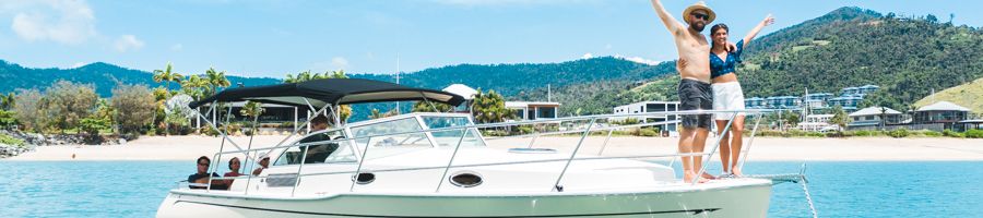 people standing on the front of a style boat in Airlie Beach