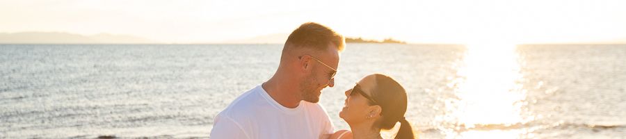 Whitsunday Sunset Cruise couple smiling on a boat at sunset in the whitsundays