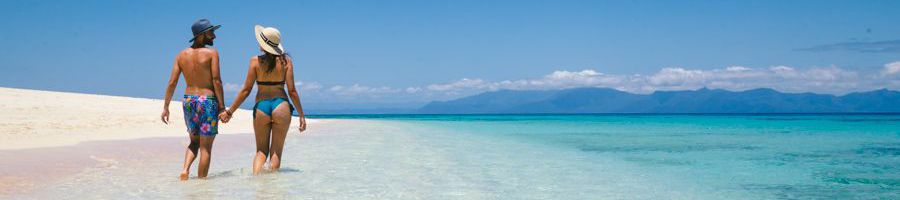 Low Isles Beach couple walking on a pristine sand beach near port douglas