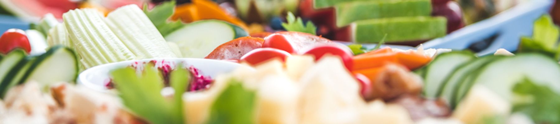 platter of food with tomatoes, pineapple, cucumber and vegetables