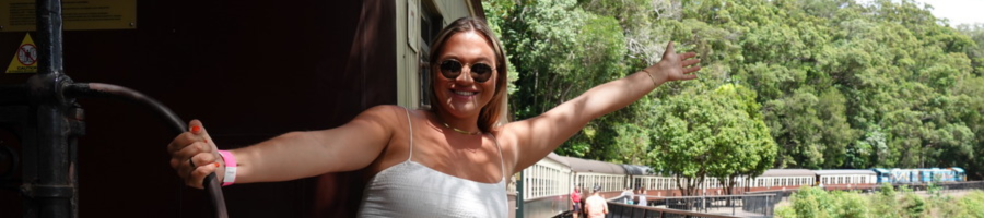 Woman in white dress on the Kuranda Scenic Railway train