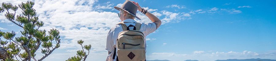 woman with backpack hiking in the whitsundays long island