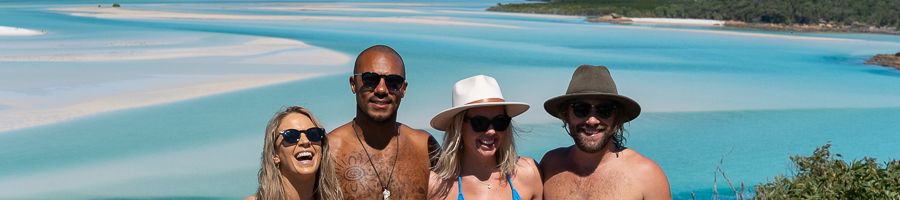 Hill Inlet Lookout Whitsundays group of four travellers smiling at hill inlet lookout whitsundays