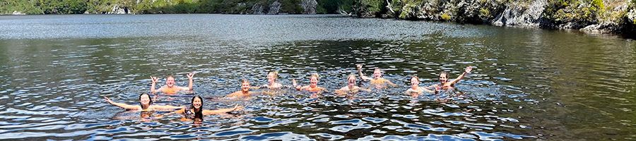 Cradle Mountain hikes and swims A group of people swimming in an Alpine Lake