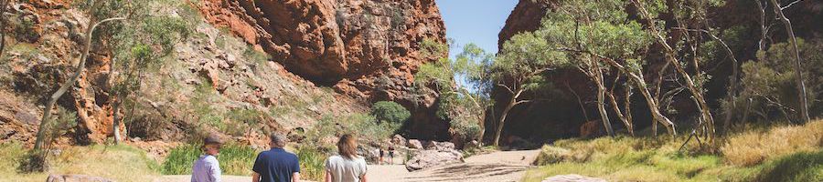 Exploring Outback Australia people walking through outback scenery on a desert hike