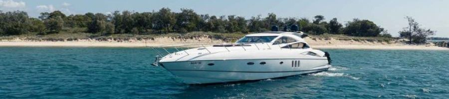 Platinum Yacht Charter platinum yacht charter near a beach on the ocean