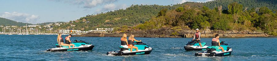 Jetski Airlie people on jetskis in the water near airlie beach