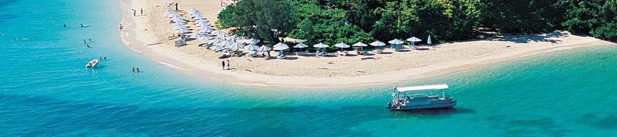 boat next to green island sandy shoes
