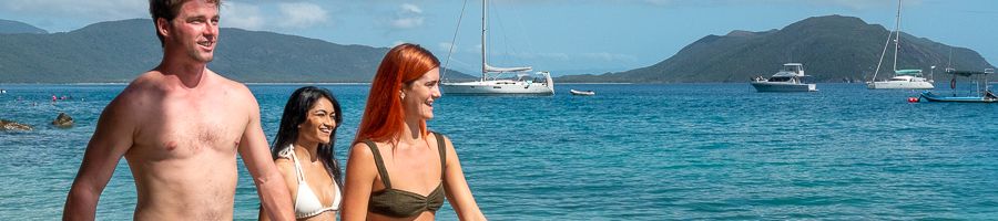 Fitzroy Island three people walking on the beach at fitzroy island