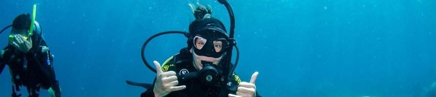 Scuba diving in Australia A woman posing for a photo underwater wearing scuba diving gear