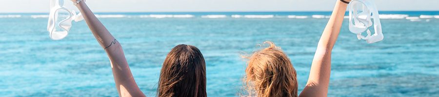 girls holding snorkel gear on a great barrier reef tour
