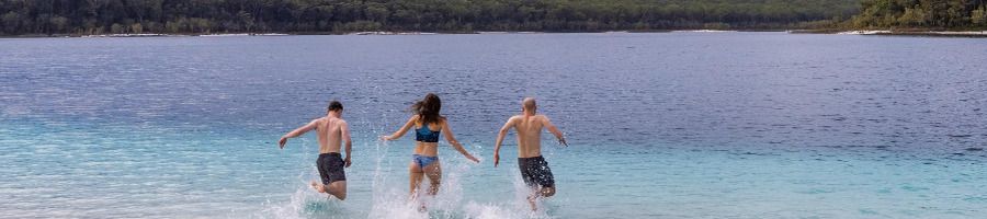 3 friends swimming in Lake McKenzie on K'gari