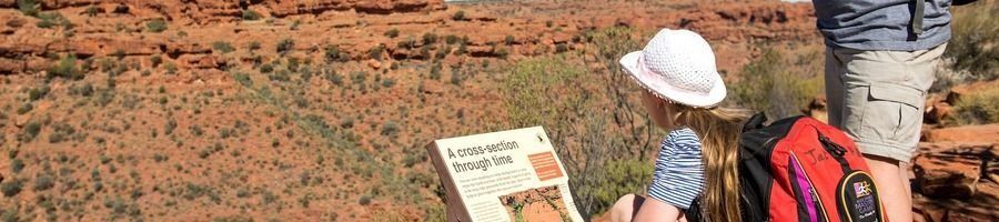 Red Centre, Australia A little girl reading a sign in the Outback