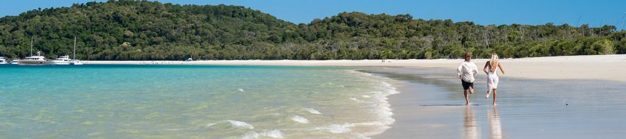 Whitehaven Beach in the Whitsundays A couple walking along Whitehaven Beach