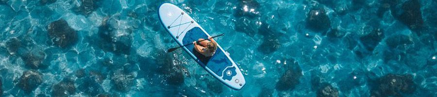 Paddleboarding person on a paddleboard in the whitsundays blue water