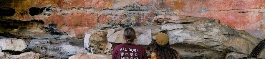 Kakadu National Park couple admiring the rock art in a cliff kakadu national park