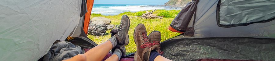 Camping Tent people with hiking boots lying in a camping tent