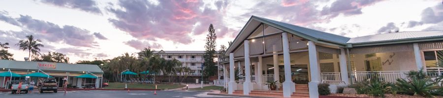 kgari beach resort buildings in front of a sunset