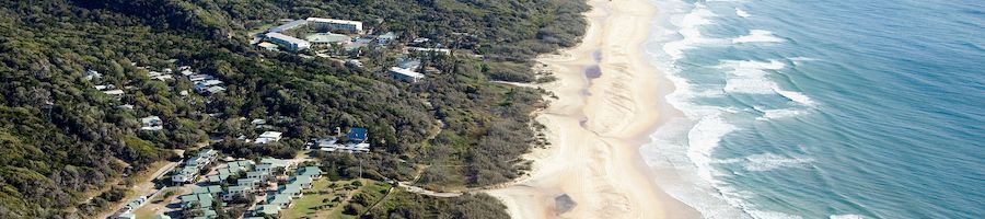 kgari beach resort next to coastline and ocean