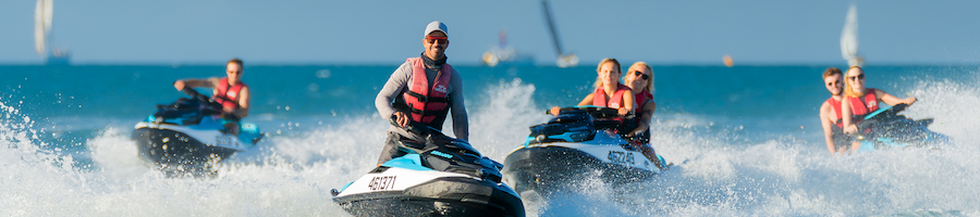 a group of people riding jetskis on a jetski tour