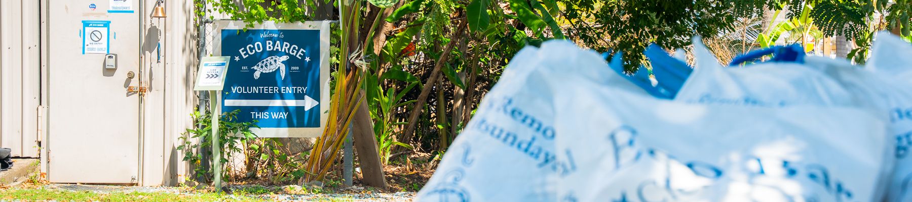 A shot of recycling next to a sign that says Eco Barge