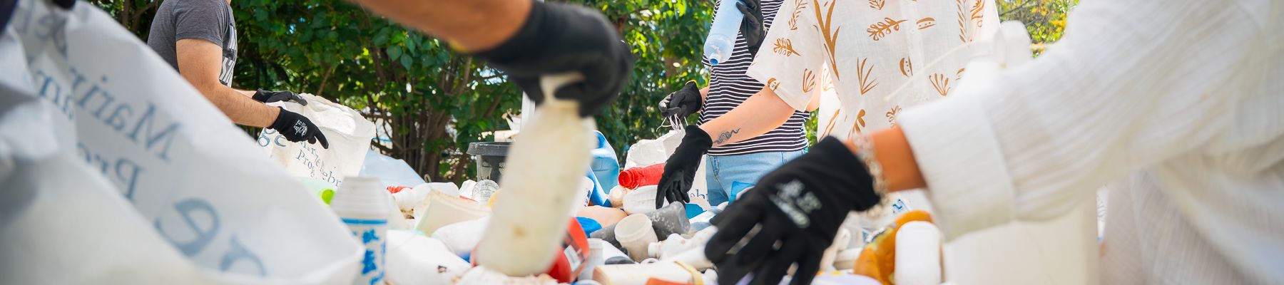 A group of people recycling plastic bottles 