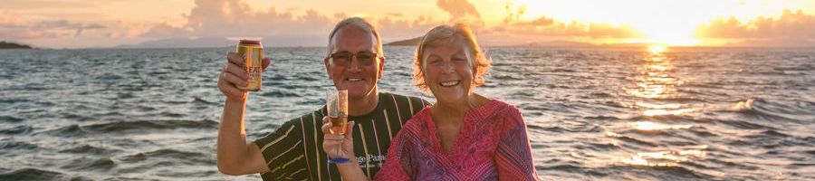 couple with drinks on a sunset dinner cruise in cairns