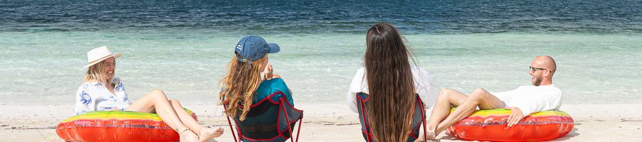 group of four adults in chairs and floats by lake mckenzie