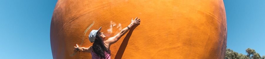 The Big Mango, Bowen, Queensland A woman standing at the Big Mango in Bowen