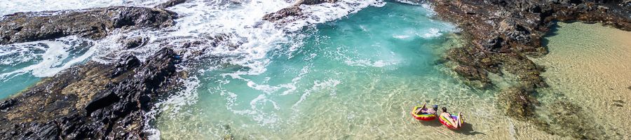 Champagne Pools K'gari people floating in the champagne pools on kgari