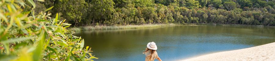 Lake Wabby K'gari girl walking past the sand dunes at lake wabby