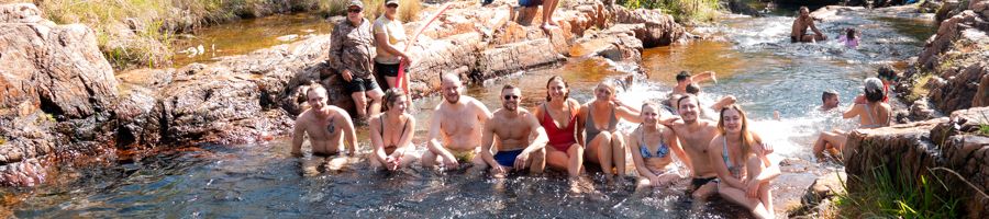 group relaxing in buley rockhole litchfield national park