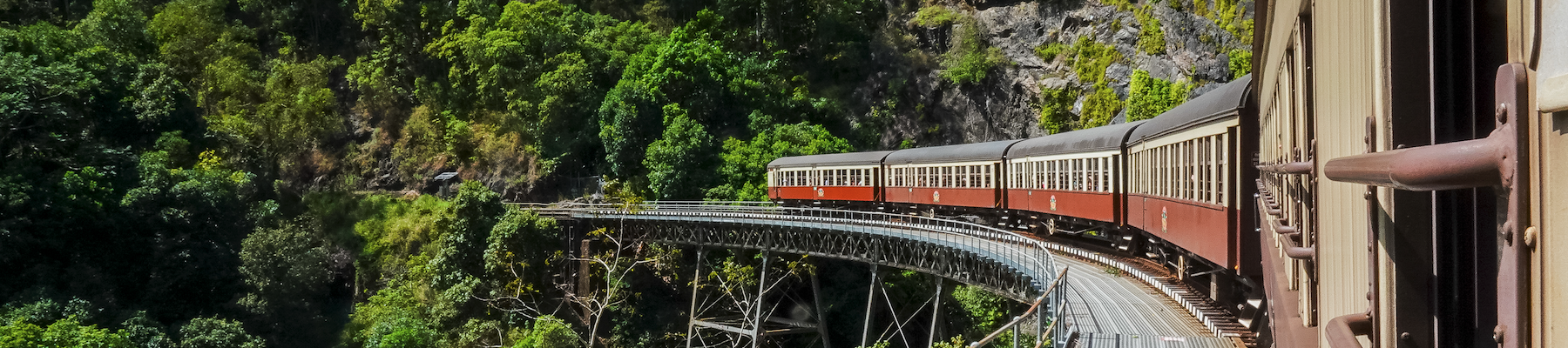 The Grand Kuranda Train a long train winding through rainforest near cairns