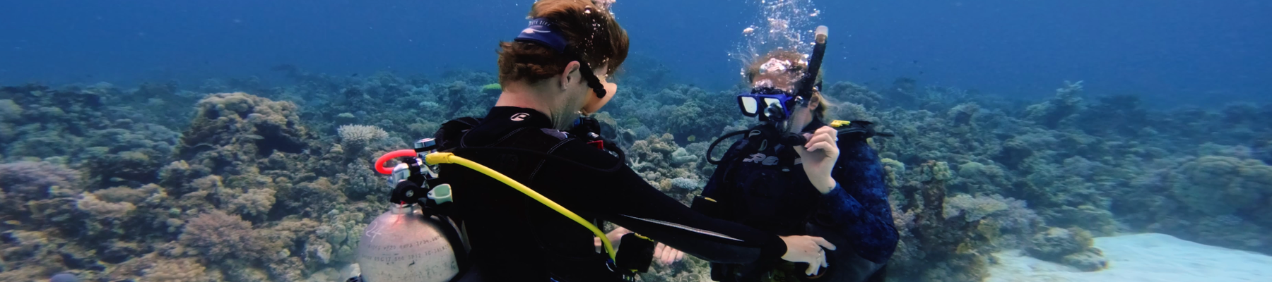 Scuba Diving a man and woman underwater practising scuba diving skills