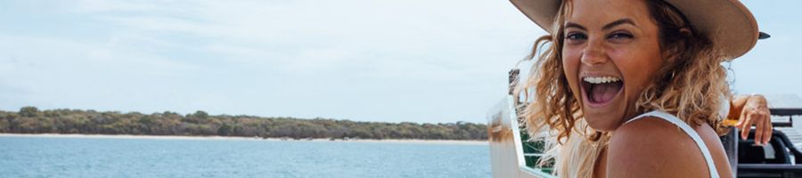 K'gari Ferry Ride girl smiling on the ferry over to kgari from rainbow beach