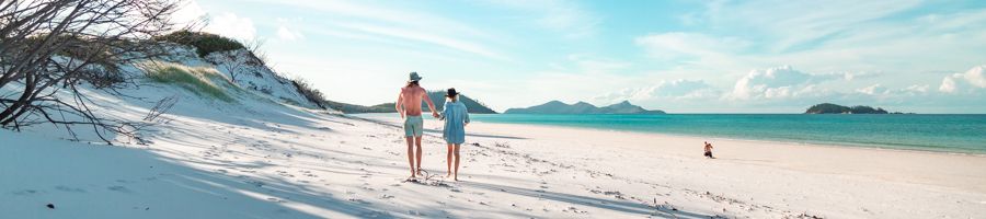 Tourists walking along Whitehaven Beach