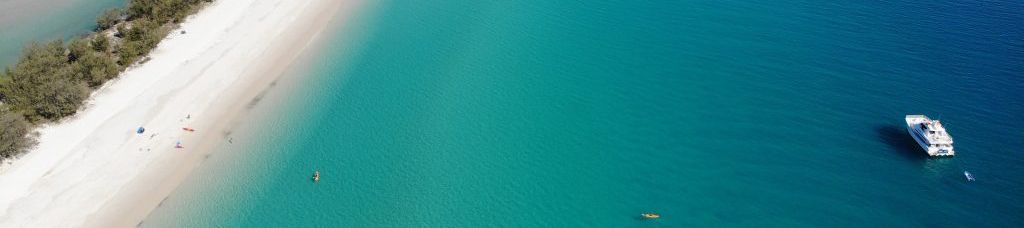 ship near the sandy beach and blue ocean of kgari
